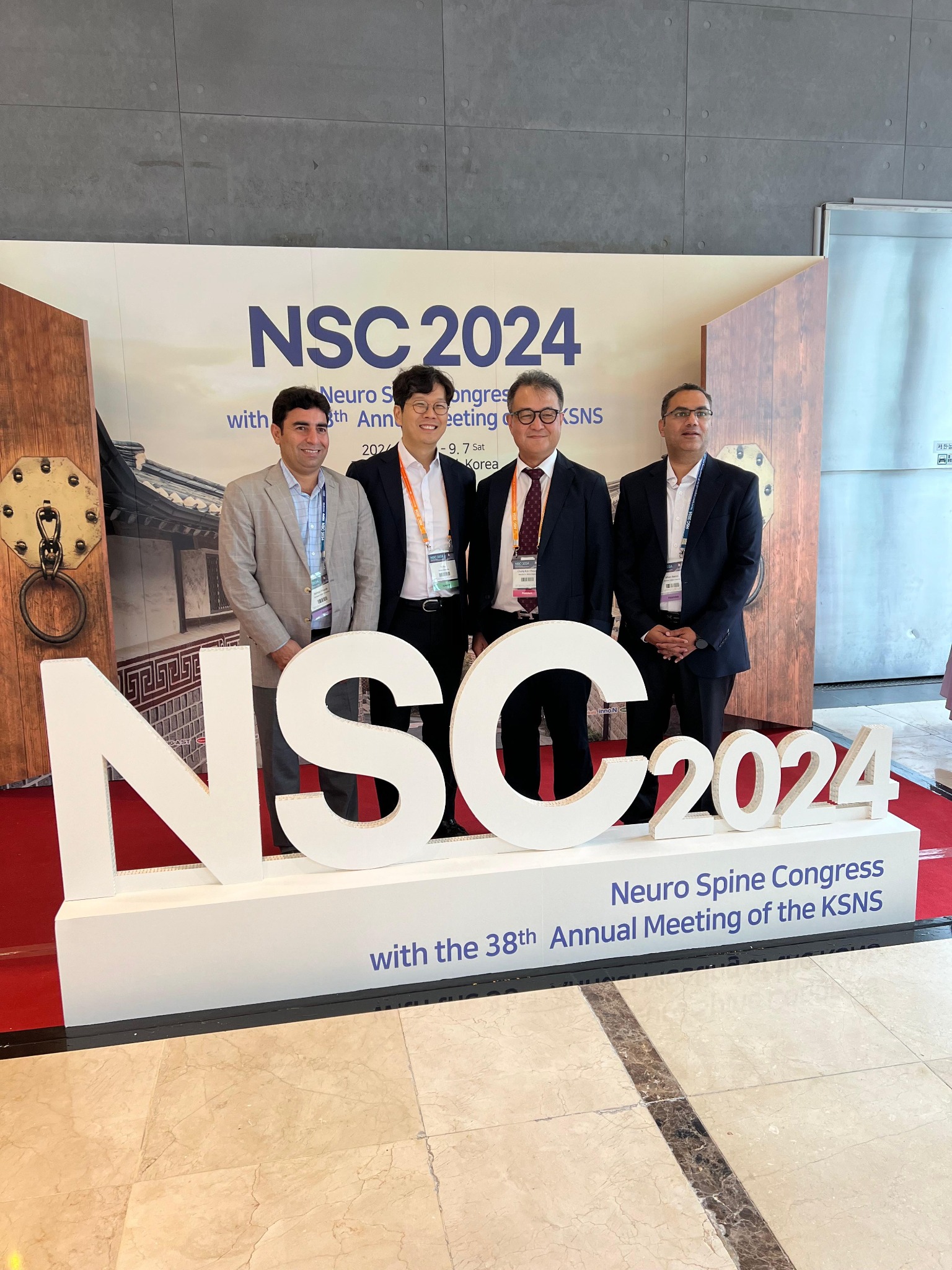 Dr. Mian Awais at NSC 2024 conference booth with international colleagues
